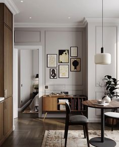 a living room filled with furniture and pictures on the wall next to a dining table