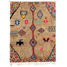 an old rug with various designs and colors on the ground, including a black dog