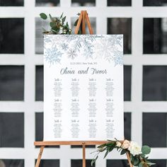 an easel with a sign and flowers on it