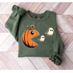 -Pumpkin Eating Ghosts Halloween Sweatshirt, Cute Pac-Man Style Fall Sweater, Spooky Pumpkin Ghost Sweater, Retro Halloween Ghost Sweatshirt Welcome to TwistTrendTee! HOW TO ORDER:   1-Explore Our Gallery: Begin by browsing all the product photos to get a clear idea of what we offer.   2-Select Your Size: Use the "shirt size" dropdown menu to choose the perfect fit. We provide a variety of sizes for T-shirts, sweatshirts, long sleeve shirts, and youth shirts.   3-Pick Your Color: Choose your pre Halloween Doodles, Halloween Moms, Ghost Sweatshirt, Pumpkin Sweatshirts, Sweatshirt Halloween, Ghost Shirt, Spooky Pumpkin, Sweatshirt Cute, Mens Fashion Fall