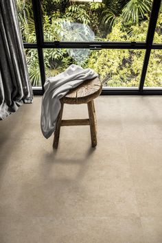 a wooden bench sitting in front of a window