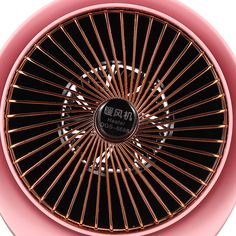 a pink fan with gold spokes on it