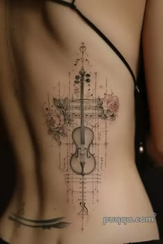 a woman with a violin tattoo on her stomach