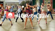 a group of young women dancing on top of a cement floor