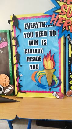 a bulletin board with an image of a basketball trophy and other sports related items on it