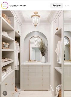 a walk in closet filled with lots of white furniture