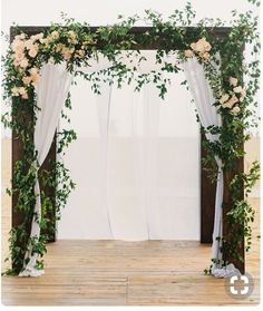 an image of a wedding arch decorated with flowers and greenery