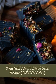 soap bars with dried flowers in them on a wooden table next to oranges and other items