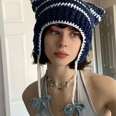 a woman wearing a blue and white knitted hat