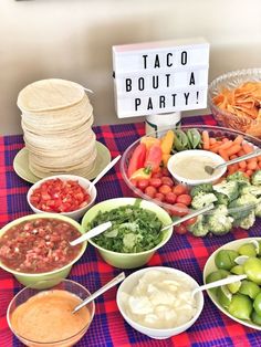 a table topped with bowls filled with different types of vegetables and dips next to tortillas