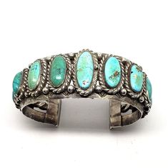 Tribal Affiliation: Navajo Artisan: unknown Provenance: Ownership History Available Country/Region of Manufacture: United States Heavy Authentic Vintage Navajo Turquoise Cuff Bracelet.  Top width is 1-1/8", interior circumference including the wrist opening is 7".  Wrist opening is 1-1/4". This antique Vintage silver Navajo Turquoise Cuff Bracelet is Circa 1940-50's's.  The beautiful unstabilized turquoise stones exhibit an array of hues and colors due to its age. This cuff is made with a heavy gauge of silver. It weighs over 3-1/2 ounces or 106 grams.  It is unsigned, which was common for its era.  Due to the thickness of the silver this bracelet would NOT easily be adjusted smaller or larger.  There are no chips or cracks in the stones. We have had the fortune over the years of being abl Collectible Bohemian Turquoise Bracelets, Collectible Bohemian Turquoise Bracelet, Bohemian Turquoise Collectible Bracelets, Bohemian Turquoise Bracelets Collectible, Antique Turquoise Adjustable Bracelet, Vintage Turquoise Bangle Cuff Bracelet, Antique Adjustable Turquoise Bracelet, Handmade Turquoise Vintage Cuff Bracelet, Antique Turquoise Bangle Cuff Bracelet