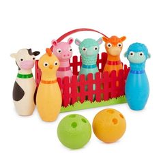 an assortment of toys including bowling balls and farm animals