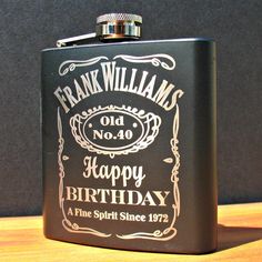 a black flask with a happy birthday message on it