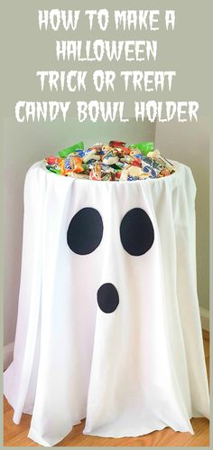 a trick or treat candy bowl holder made out of white cloth with black eyes on it