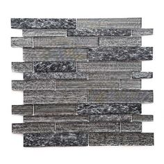 a gray and black mosaic tile wall with different shades of grey tiles on the side