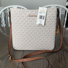 Michael Kors New Jet Set Travel Crossbody. Beautiful Vanilla Leather With Accenting Mk Logo, Brown Accent Trim And Adjustable Strap, Exterior Snap Pocket, Interior Open And Zippered Pockets God Accent Hardware And Hang Tag. Beautiful Bag. Retail $298. New With Tags And In Excellent Condition. New Jet, Tan Purse, Mini Crossbody Purse, Purple Purse, Travel Crossbody, Accent Trim, Bags Michael Kors, Michael Kors Crossbody Bag, Adjustable Bag