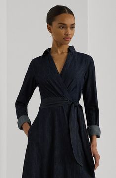 Dark-rinsed denim adds a casual note to a tailored shirtdress popped with a pair of handy pockets and cut to a beloved and versatile midi length. 44 1/2" length (size 8) Hidden side-zip closure Spread collar Surplice V-neck Long sleeves with one-button cuffs Side-seam pockets 100% cotton Machine wash, line dry Imported Chic Button-up Denim Dress For Work, Elegant Collared Denim Dress For Work, Elegant Button-up Denim Dress With Pockets, Denim Knee-length Shirt Dress For Work, Elegant Button-up Denim Dress For Fall, Fitted Collared Denim Dress For Work, Collared Denim Dress For Spring Workwear, Spring Collared Denim Dress For Work, Elegant Belted Denim Dress