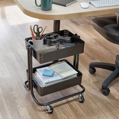 an office desk with a laptop computer on top of it and two drawers in the middle