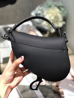 CHRSTN DR Mini Saddle Bag Black Ultramatte For Women 19.5cm/7.6in CD Rep 1:1 Measurements: 19.5 x 16 x 6.5 cm / 7.6 x 6.2 x 2.5 in The iconic Saddle bag, crafted in white , is reimagined by Maria Grazia Chiuri. The legendary design is embellished with a Dior Oblique perforations motif and features a Saddle flap with a magnetic ‘D’ stirrup clasp and an antique finish metal ‘CD’ signature on either side of the strap. The bag has a wide embroidered strap, both adjustable and Elite Outfits, Dior Mini Saddle Bag, Mini Saddle Bag, Dior Oblique, Book Tote Bag, Gucci Gg Marmont, Maria Grazia, Luxury Products, Evening Clutch Bag