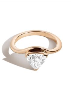 a gold ring with a pear shaped diamond