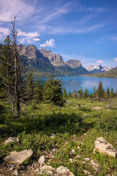 a scenic view of the mountains, water and trees