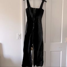 *Gently Used* Black Jumpsuit With Front Button Detailing From Reformation. Size: 2 Chic Overalls With Button Closure For Workwear, Chic Workwear Overalls With Button Closure, Fitted Overalls With Buttons For Workwear, Fitted Overalls With Buttons, Chic Black Jumpsuits And Rompers With Buttons, Black Overalls And Rompers With Buttons, Black Overalls With Buttons, Black Jumpsuits And Rompers With Buttons, Chic Fitted Black Overalls