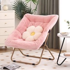 a pink chair with a flower on it