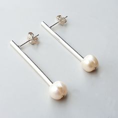 "Sterling silver tube and pearl stud earrings are super comfortable, light and delicate, great for everyday wear and a contemporary look. Earrings length: 3.5cm (1.4\") sterling silver butterfly backs Natural pearl: Class AA With any questions or comments feel free to convo me. There is available a wide range of natural stones of different colors and sizes to your taste. For custom order leave me a message. Back to the shop: https://www.etsy.com/shop/SorrisoDesign For proper care, please avoid t Sterling Silver Cufflinks, Bar Stud Earrings, Minimalist Studs, Bar Studs, Anniversary Gifts For Him, Eco Fashion, Pearl Stud Earrings, Pearl Studs, Jewelry Earrings Hoops