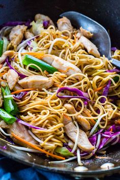 a bowl filled with noodles, chicken and veggies