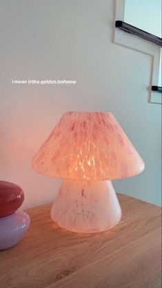 a lamp sitting on top of a wooden table