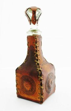 an old fashioned leather bottle with a metal stopper