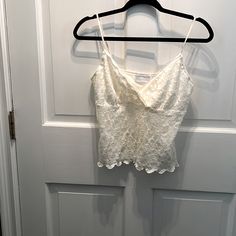 Nwt Lined Off White Lace Camisole.98% Nylon And 2% Spandex. V-Neckine With Cross Cross Bodice . Adjustable Lingerie Straps . Fitted V-neck Lace Top Camisole, White V-neck Crop Top Vest, White V-neck Vest Crop Top, White Lace Fitted Tank Top, White V-neck Lace Tank Top, White Lace V-neck Tank Top, Fitted V-neck Camisole For Day Out, Chic V-neck Lace Crop Top, White Lace Top V-neck Camisole