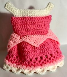 a crocheted pink and white dress is on display