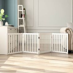 a baby crib in the middle of a living room next to a couch and chair