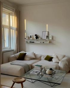 a living room filled with furniture and a glass coffee table