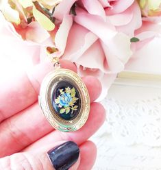 "A gorgeous gold plated photo locket adorned with a lovely vintage black glass limoges with blue rose and gold and green leaves dangles so pretty from a 16k gold plated link chain with lobster clasp. Locket has a lovely floral etched pattern Total length of chain measures 18\" Locket measures 23x30mm Cameo measures 18x13mm Locket is high quality and nickel free Your purchase will come beautifully wrapped ready for gift giving" Black Enamel Oval Necklace For Gift, Black Enamel Oval Necklace As Gift, Oval Black Enamel Jewelry Gift, Victorian Rose Design Jewelry For Formal Occasions, Elegant Cameo Jewelry Keepsake, Elegant Cameo Keepsake Jewelry, Victorian Black Enamel Necklace For Gift, Heirloom Black Enamel Jewelry As Gift, Antique Black Enamel Necklace For Gift