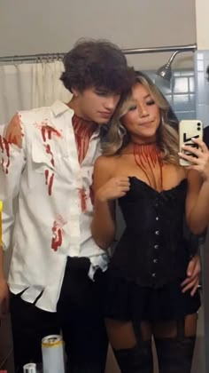 two people dressed up as zombies in a bathroom