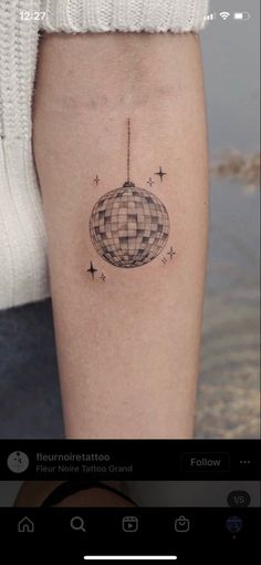 a person with a small tattoo on their leg that has an image of a globe