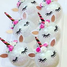 these unicorn - shaped cake pops are decorated with glitter and flowers