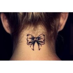 a woman's neck with a bow tattoo on her left side ribcage