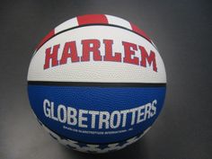 a close up of a basketball on a black surface with the word harlem written on it