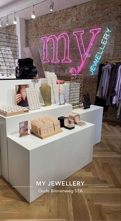 the inside of a clothing store with many items on display