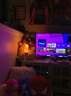 a room with two monitors and stuffed animals