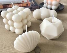 some candles are sitting on a table next to books