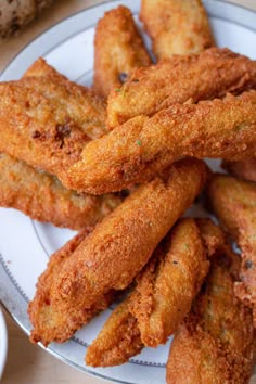 some fried food on a white plate with the words, how to make hawaiian akra aa