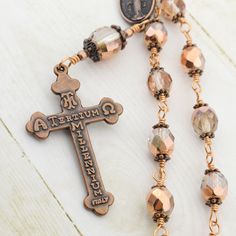 "One decade Catholic rosary beads with Miraculous medal and Eucharistic crucifix. Single decade pocket rosary is made in unbreakable wire wrapped technique with 8mm and 12mm crystal half metallic copper Czech glass beads and antique copper medal and crucifix. Our Czech glass beads are sourced directly from high quality Czech glass factory. All of the materials used in making rosaries are hand picked and undergo utmost quality check. Rosary's length is about 8\" (21 cm) Crucifix: 1.1\"x 1.8\" (2. Handmade Bronze Spiritual Rosary, Handmade Spiritual Bronze Rosary, Antique Jewelry With 8mm Beads For Gift, Antique Jewelry With 8mm Beads As Gift, Antique 8mm Beads Jewelry As Gift, Bronze Rosary With Round Beads As Gift, Handmade Bronze Rosary As A Gift, Bronze Rosary As Gift, Vintage Bronze Rosary As Gift