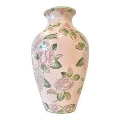 a pink vase with flowers painted on it