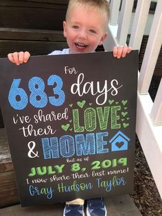 a young boy holding up a chalkboard sign that says, for 85 days i've shared their love and home