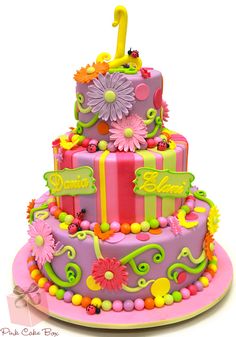 a three tiered cake decorated with flowers and numbers