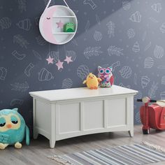 a child's room with toys and wallpaper on the walls, including a toy chest